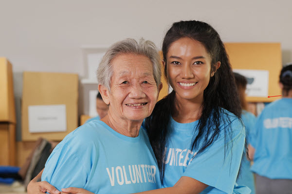 Older woman and a younger woman hugging