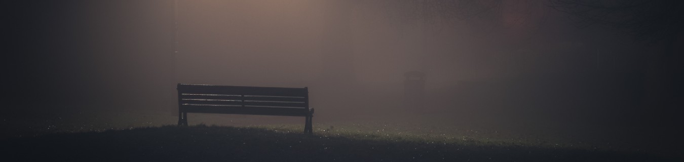 Park bench on foggy night