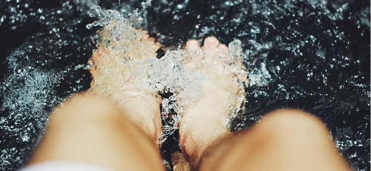 feet splashing in water