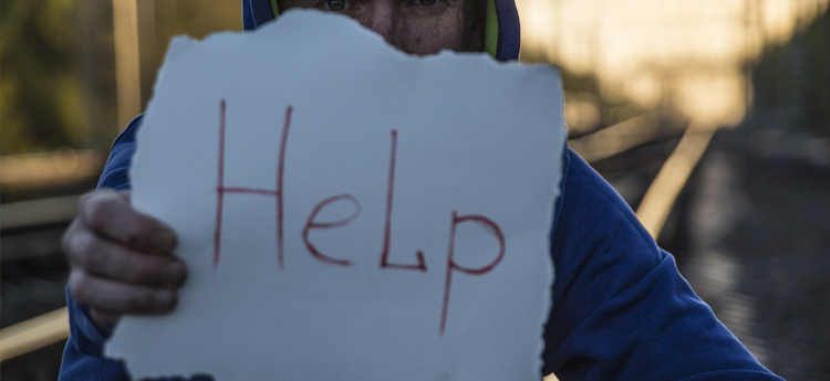Person holding sign that says help
