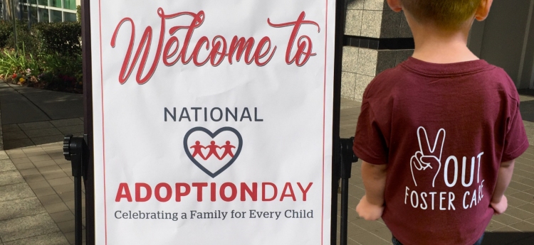 Welcome to National Adoption Day - Celebrating a family for every child - Small child wearing shirt  Peace out Foster Care