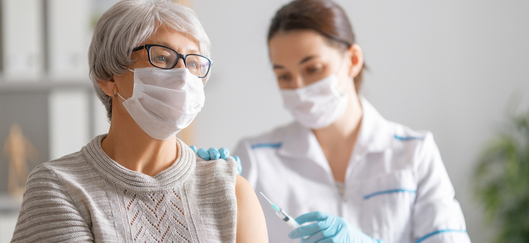 Elderly woman receiving a vaccine 