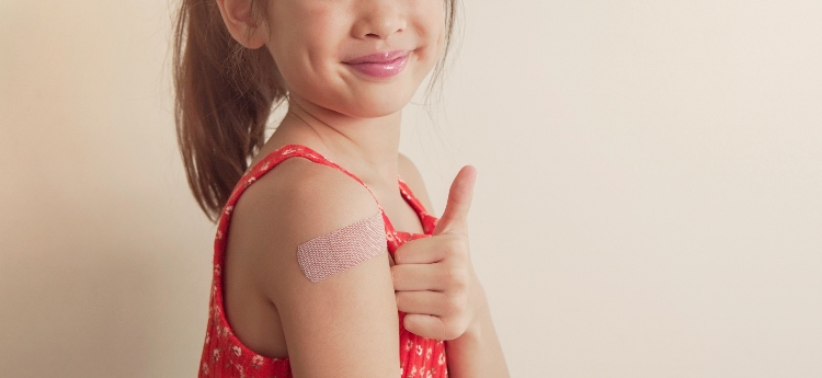 Small child with a bandaid after receiving a vaccination