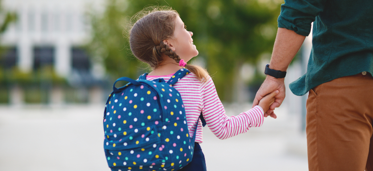 Father and daughter walking to school