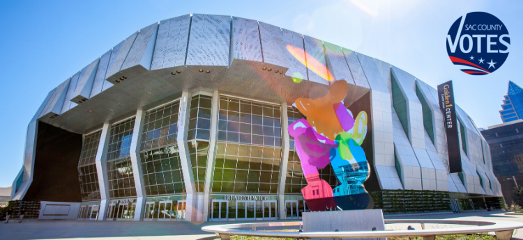 Exterior photo of Golden 1 Center with SacCounty Votes logo