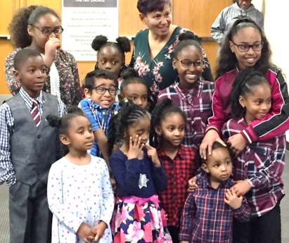 Suzzanne Goldwire with grandchildren and two adopted children at the Adoption Day event.