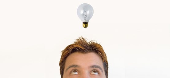 Man looking puzzled by old light bulb