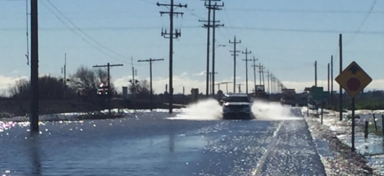 SUV Driving down a flooded Franklin Blvd.