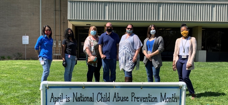 SAFE Center Team Members Standing in front of a building with a banner in the foreground
