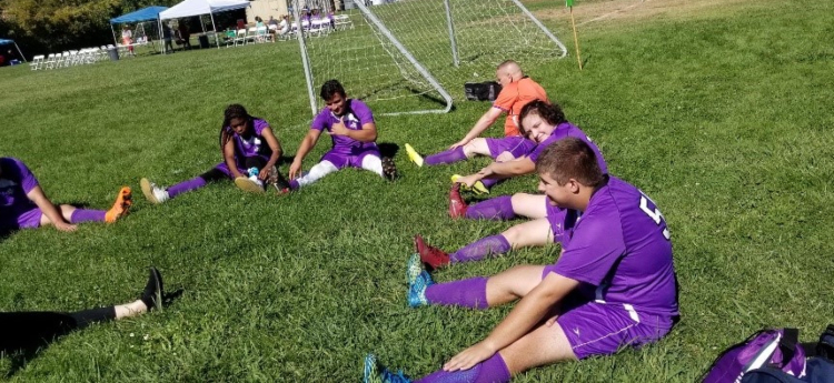 Members of the Sacramento County Chargers soccer team, stretching before a match. 
