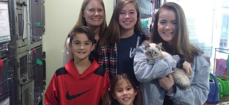 Happy family posing with their new kitten