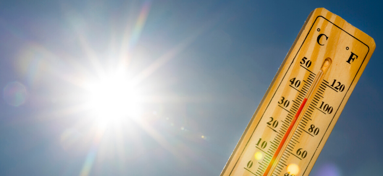 Thermometer with sun in the background