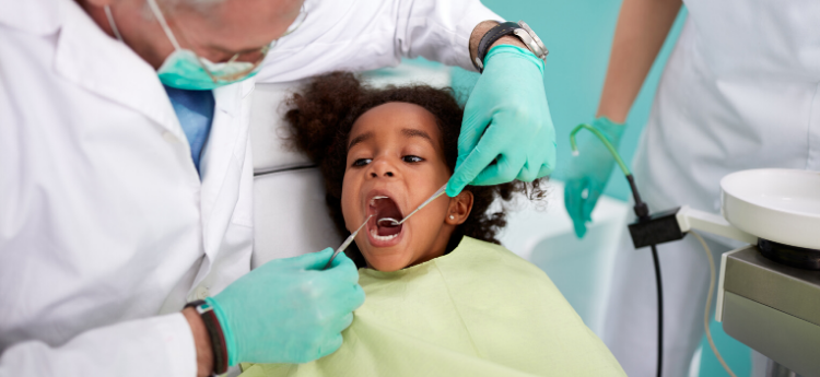Young child having teeth examined by a dentist