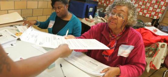 Handing out an election ballot